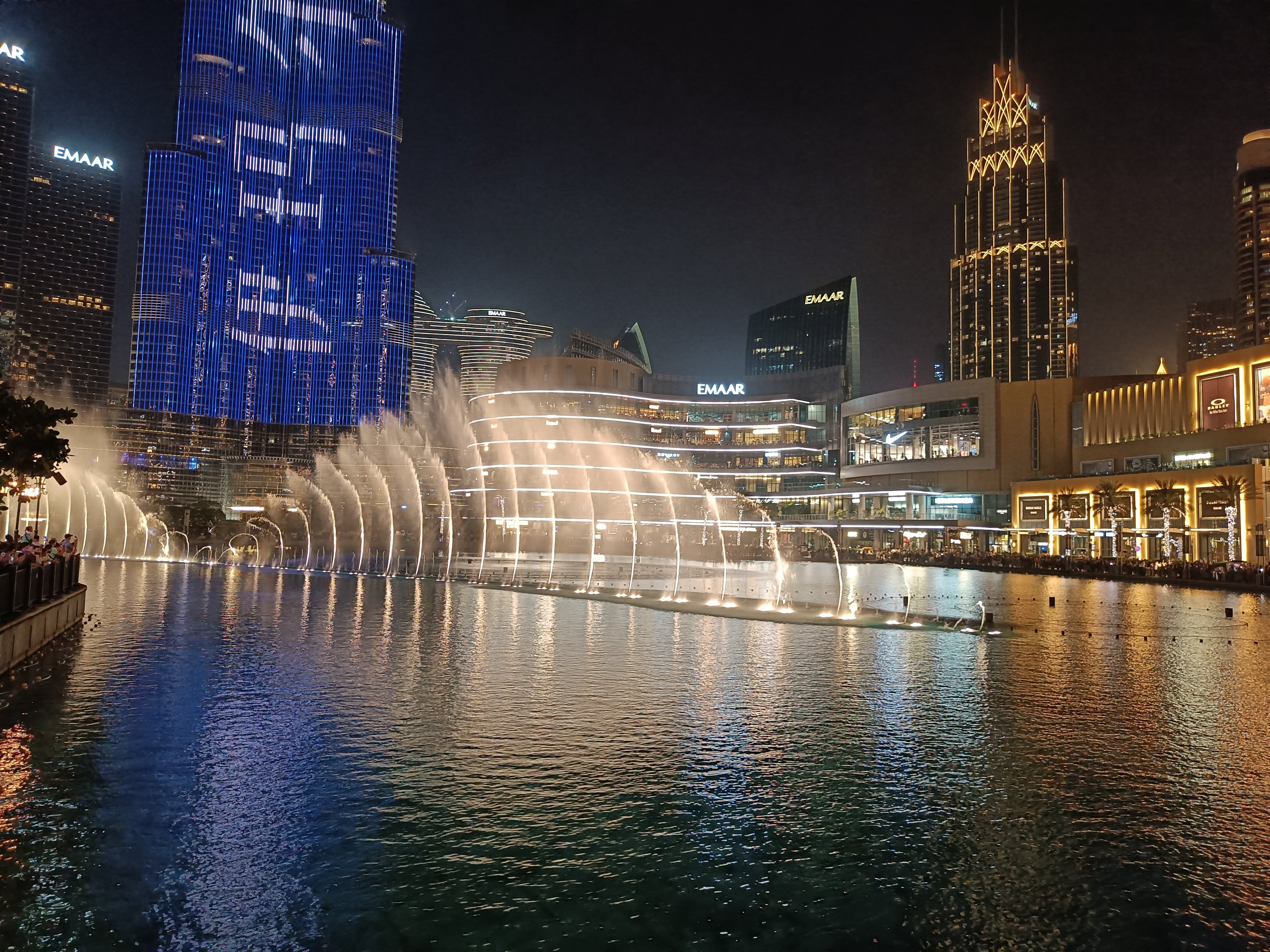Dubai Fountain water show with choreographed jets illuminated at night - largest choreographed fountain system in the world